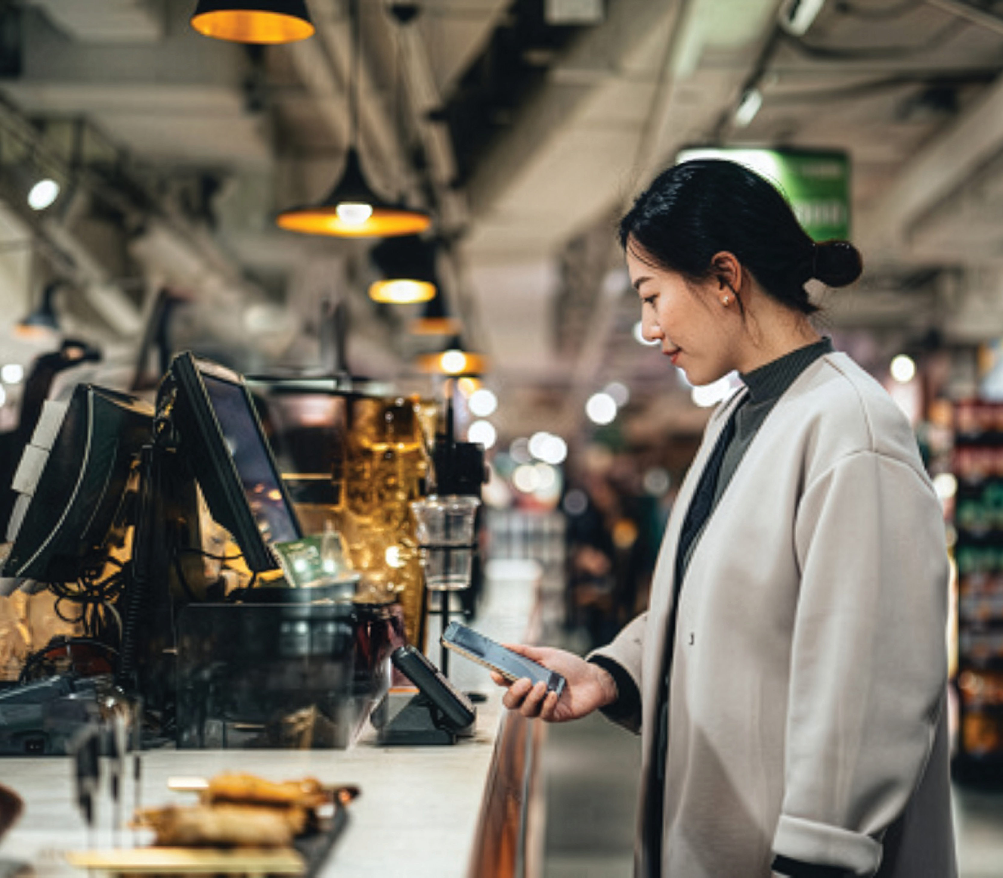 Retail consumer experience — woman at checkout counter